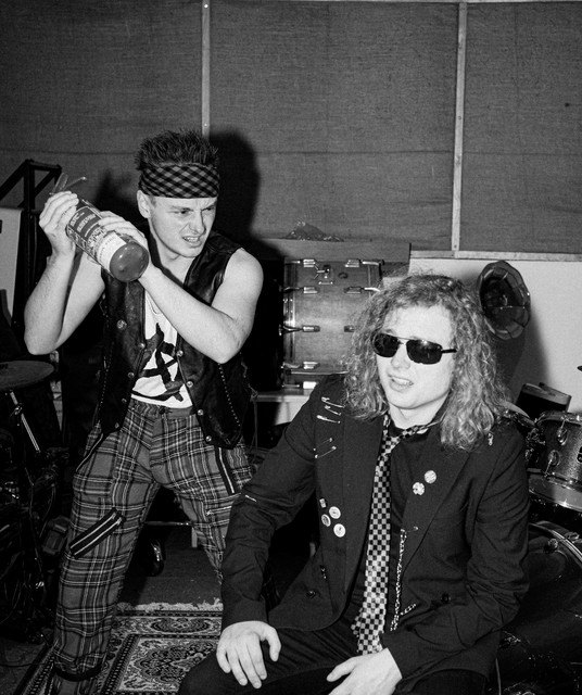Black and white photo of Doctor Smackpot, in his bandana, about to spray Johnny Sideways with a fire extinguisher in their practice room